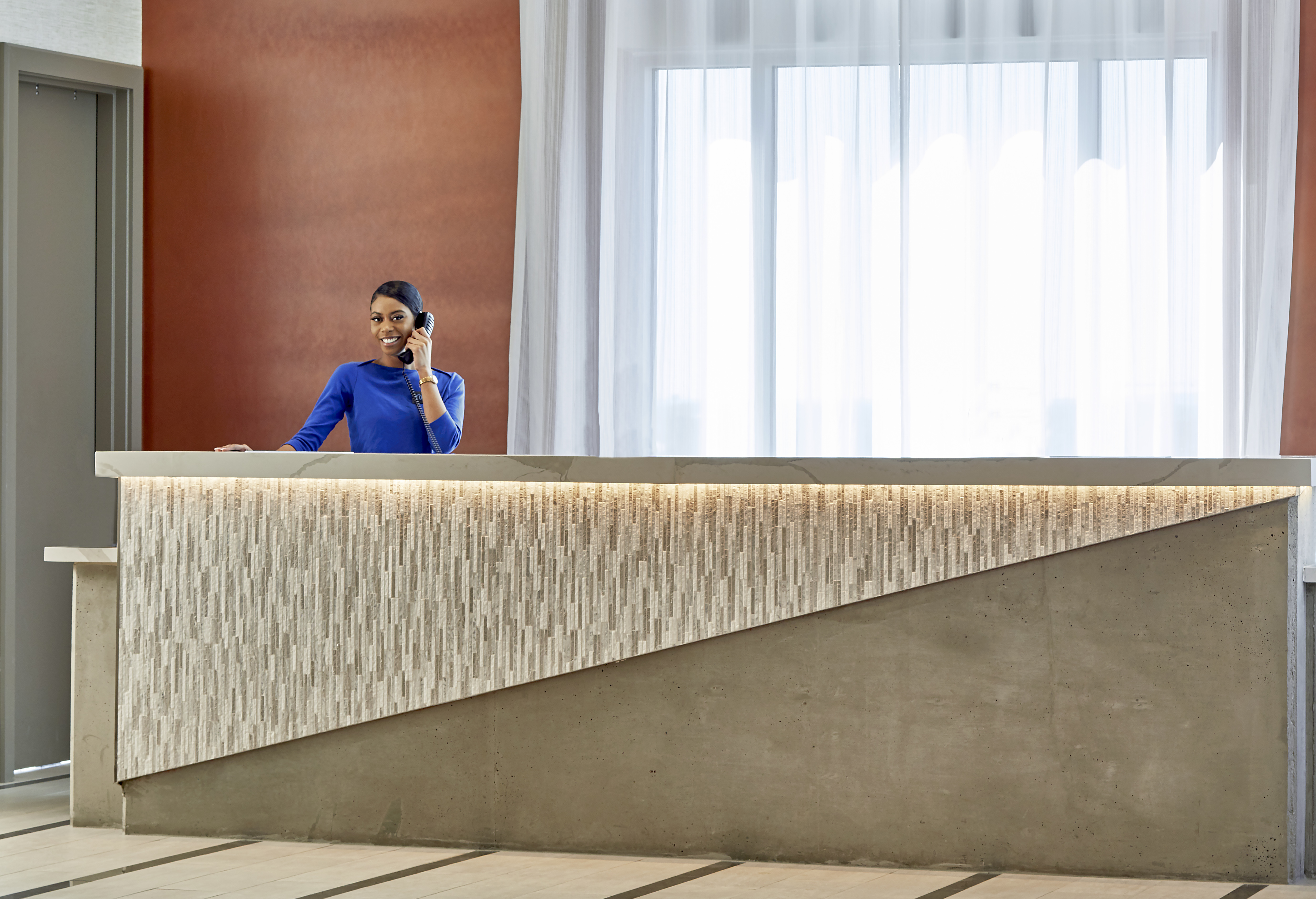 a hotel front desk with an attendant