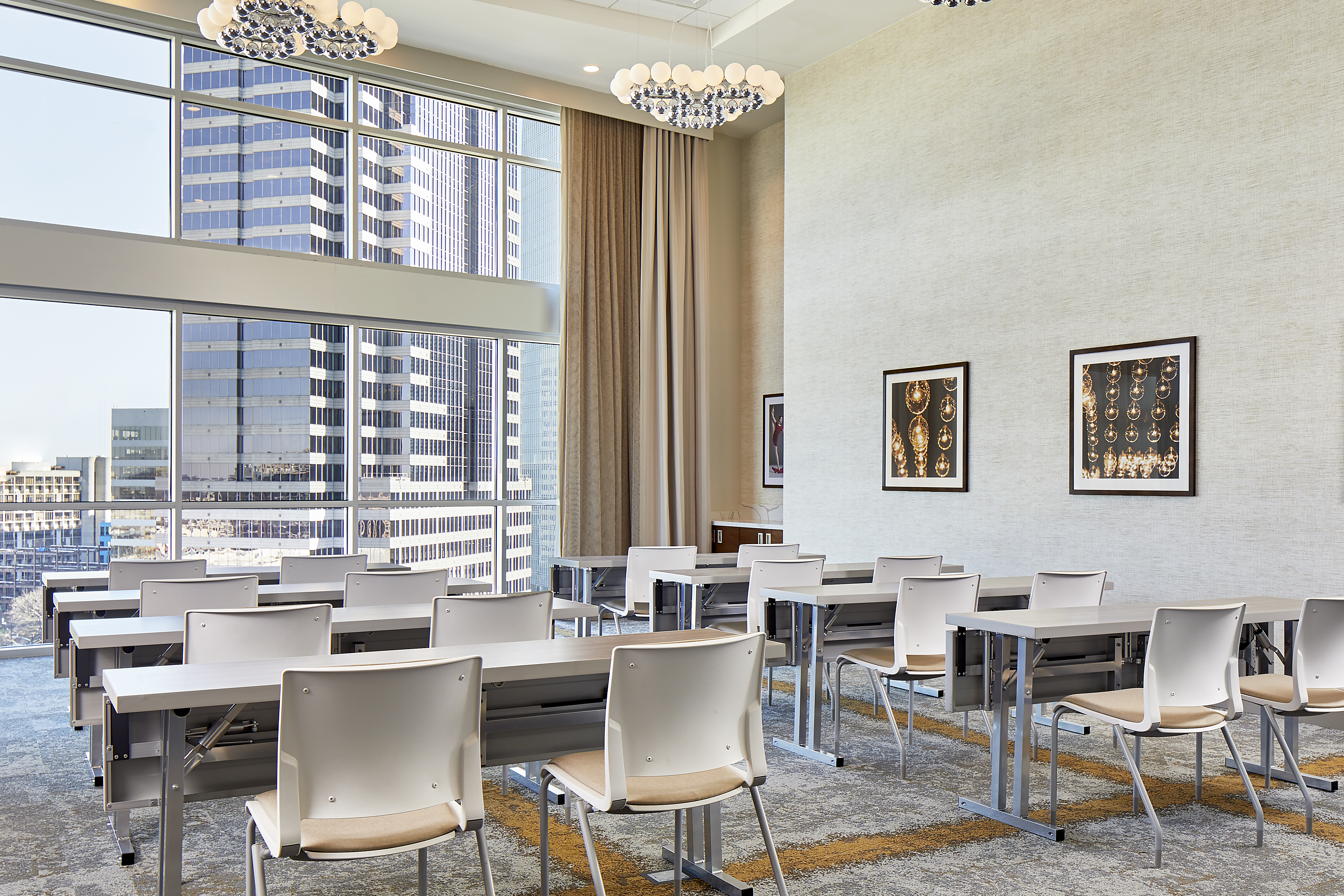 classroom tables in a meeting room with skyline view