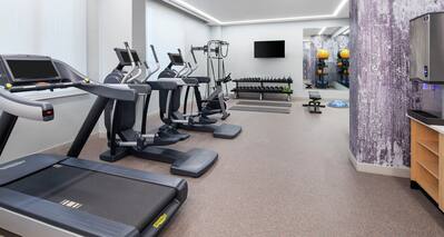 Fitness Center with Treadmill, Elliptical Machines, Dumbbells, and Room Technology