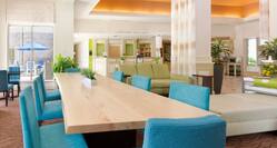 Large table and seating area in Hotel Lobby.