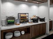 Breakfast Bar Area with Waffle Makers and Bread Selections