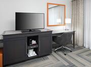 Suite Bedroom With Television and Workspace