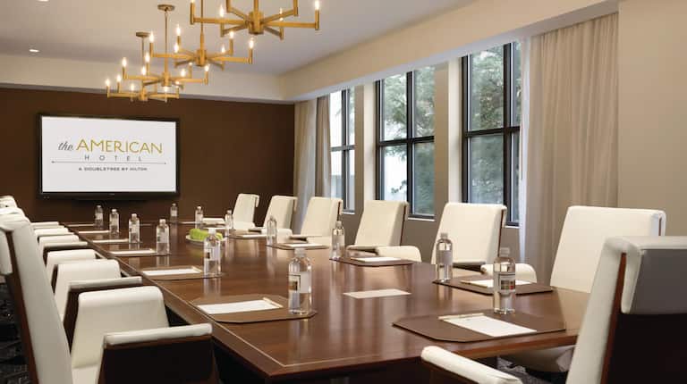 Meeting room in boardroom setup with Projector Screen