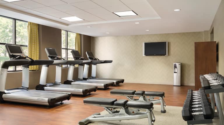 Fitness Center view with treadmills, free weights area, and HDTV