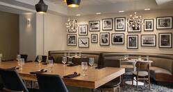 View of Wall Photography and Communal Table with comfortable seating in The Cloakroom Kitchen & Ba
