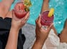 people drinking cocktails by pool