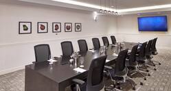 Wall Art and Seating For 12 Around Boardroom Table Facing HDTV in Conference Center