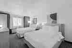 Accessible guest room with two queen beds and spacious floor area.