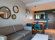 Suite lounge with sofa, dining table and wetbar