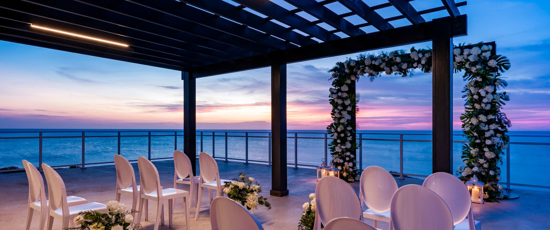 wedding ceremony set up on the terrace overlooking the water
