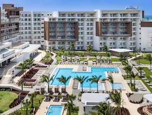 Embassy Suites by Hilton Aruba Resort, overview of the outdoor pool and hotel exterior