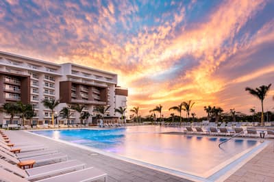 outdoor pool, hotel exterior at sunset