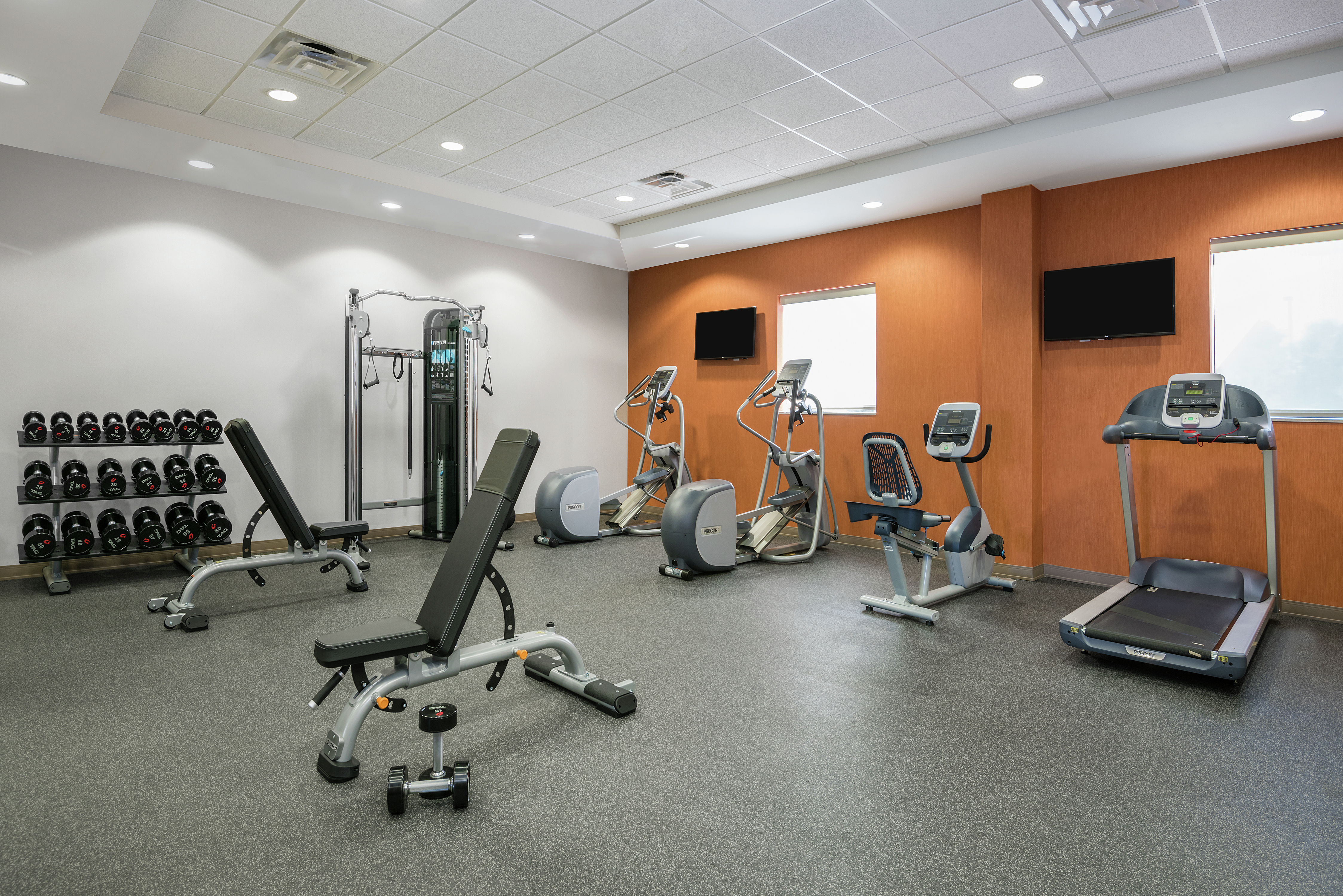 Fitness Center With Cardio Equipment, TVs, Windows, Weight Benches, Free Weights, and Weight Machines in Spin2Cycle Fitness Area