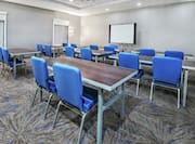 Meeting Room with Classroom Setup and Projector Screen