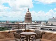 Daytime View of the Texas State Capital Building from Executive Suite Patio With Table and Four Chairs