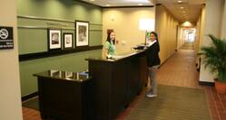 Angled View of Guest and Team Member at Front Desk