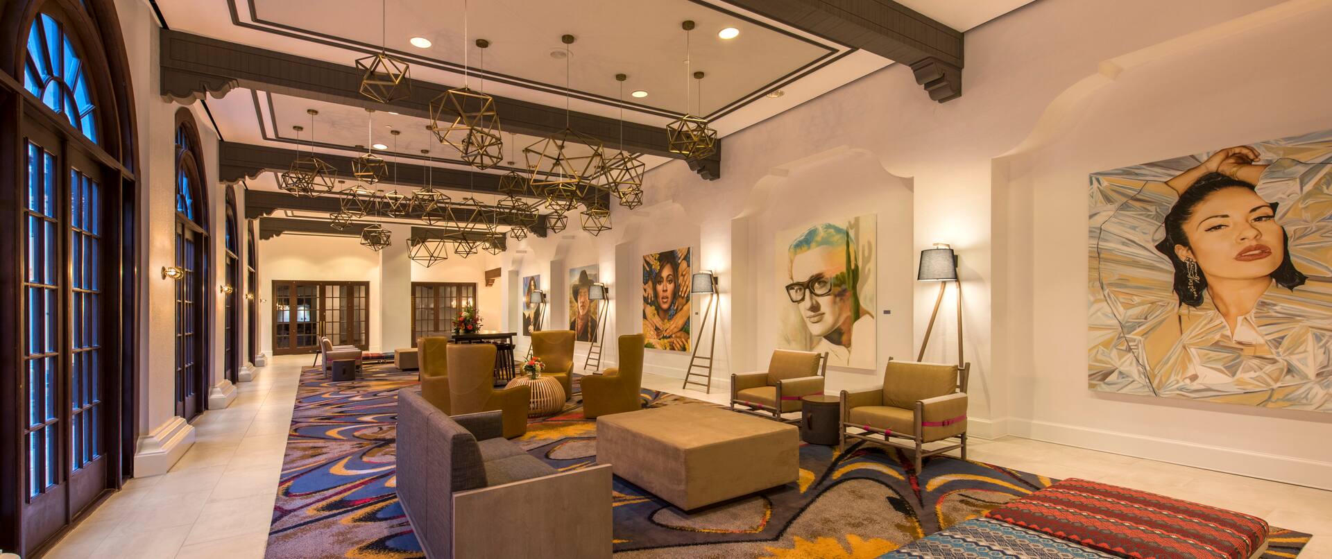 Soft Seating, Decorative Lighting, and Custom Austin Artwork on Walls in Lobby Colonnade
