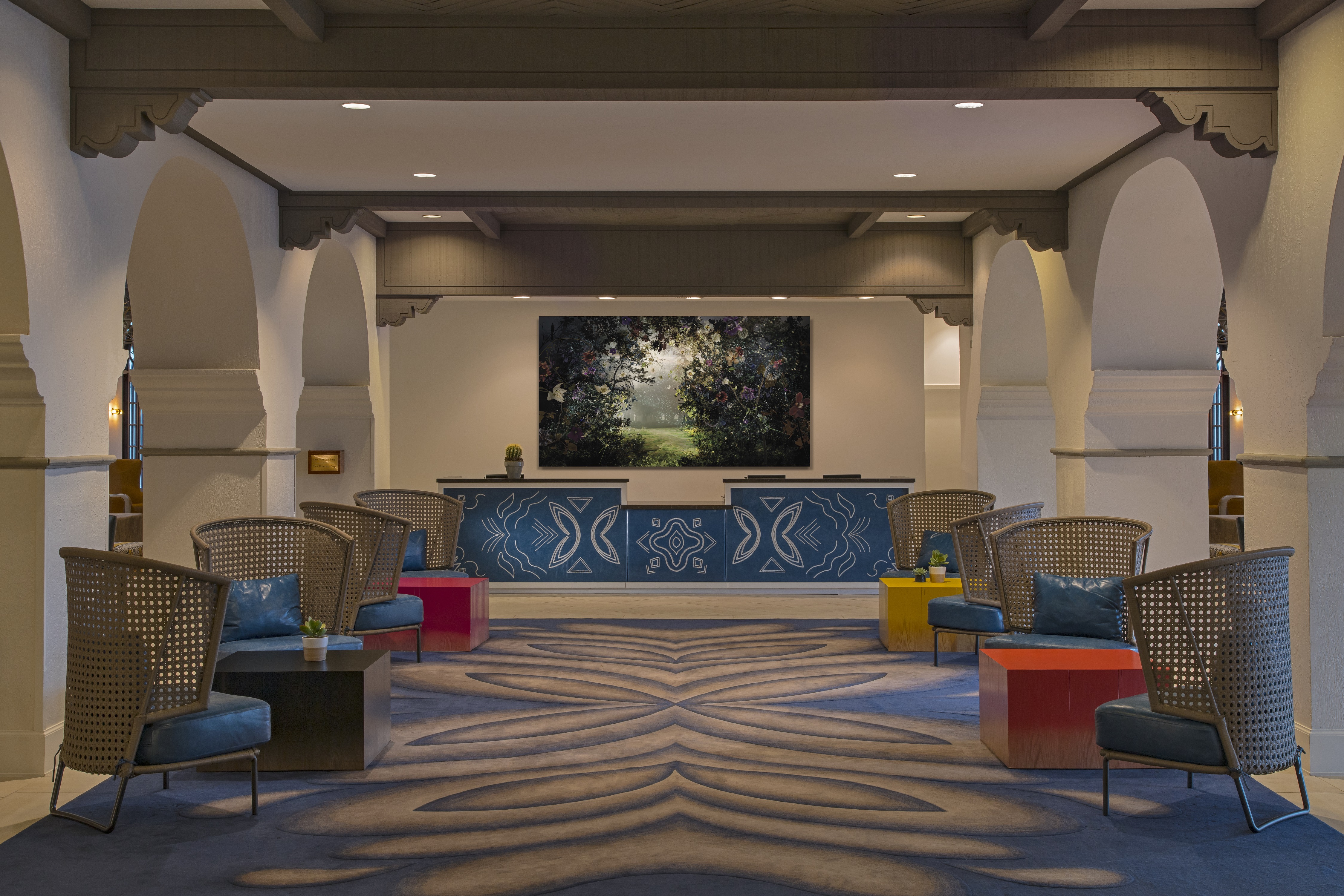 View of Tables, Lounge Seating and "Prelude" Wall Art by Ysabel Lemay Behind Front Desk