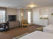 Premium Room With Two Double Beds, Work Desk, TV, Armchair, Hospitality Area, and Wall Art