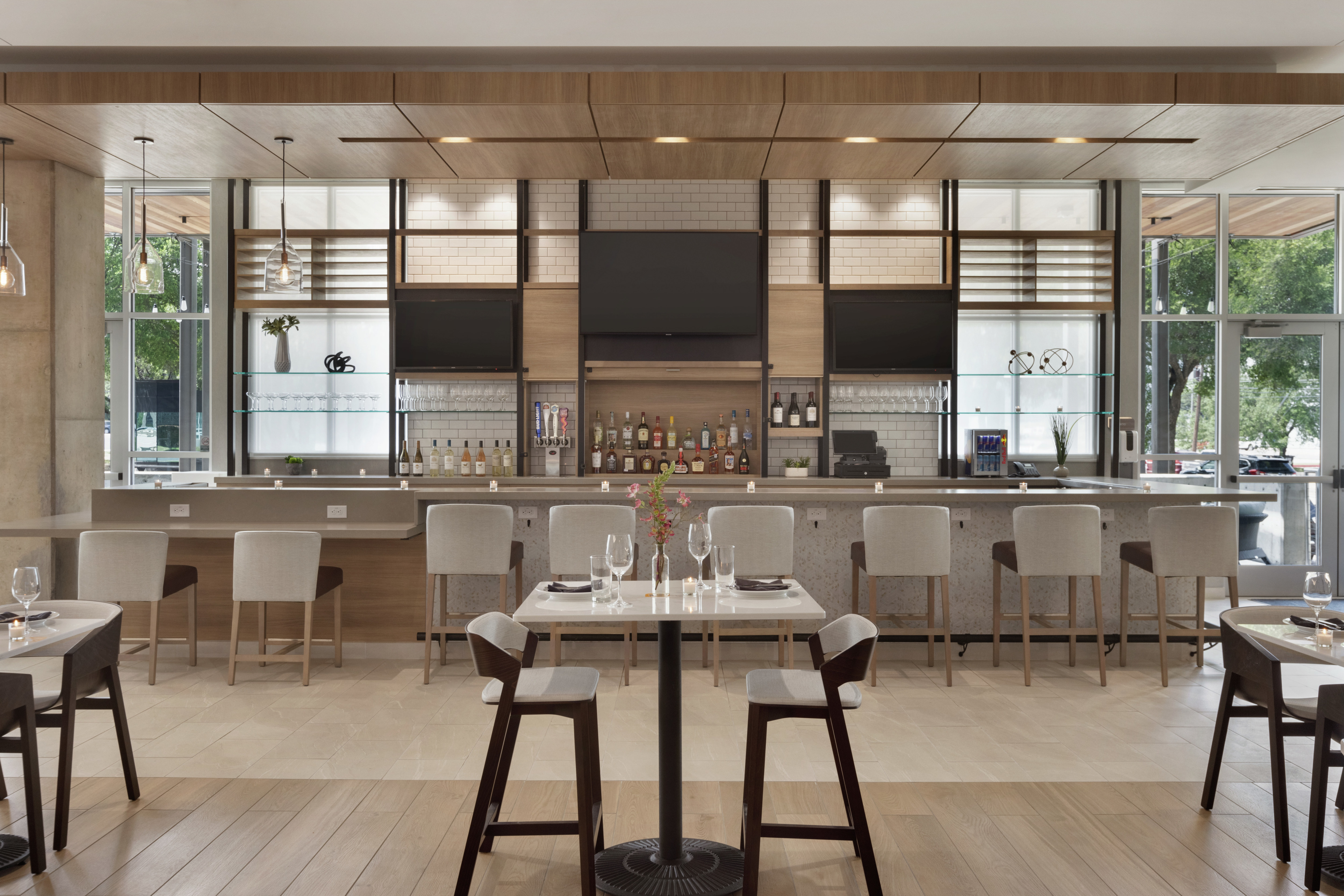 Beautiful hotel bar featuring bright natural light, ample seating, and sophisticated design.