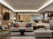 Spacious lobby area featuring stylish design, lounge area, bar, and dining.