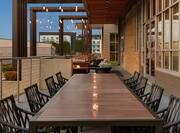 Beautiful outdoor patio area for guests to relax featuring large table set with candles.