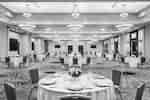 Spacious hotel ballroom featuring wedding setup with ample seating and stunning design.