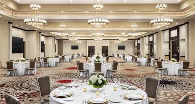 Spacious hotel ballroom featuring wedding setup with ample seating and stunning design.