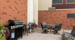 Outdoor Patio Seating Area with Chairs, Tables and BBQ Grill