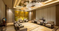 Lounge Area of VIP Room With Soft Seating, Decorative Lighting, and Large Wall Art Feature