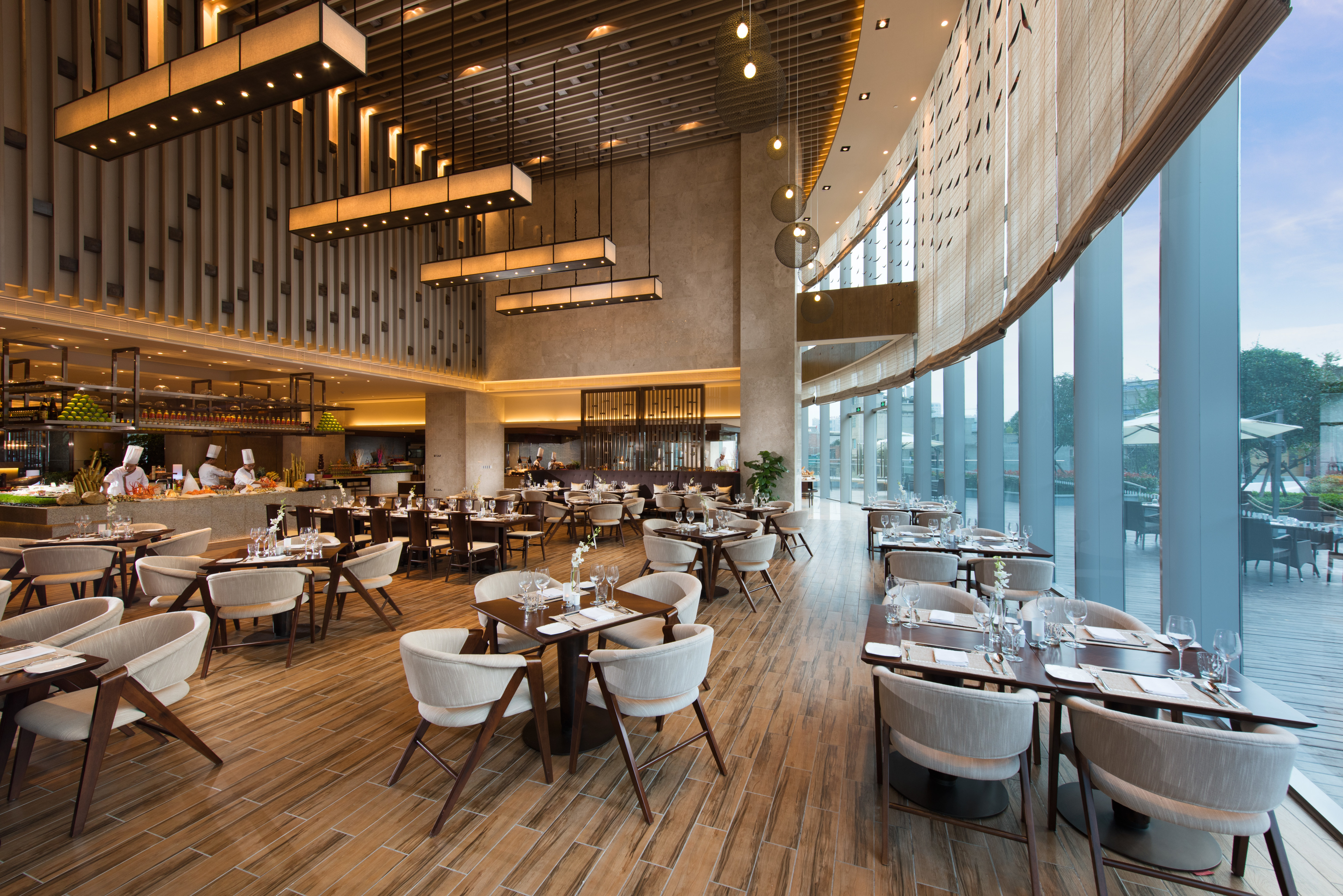 Decorative Lighting, Large Windows With View, Three Chefs in Food Service Area, and Dining Seating Options