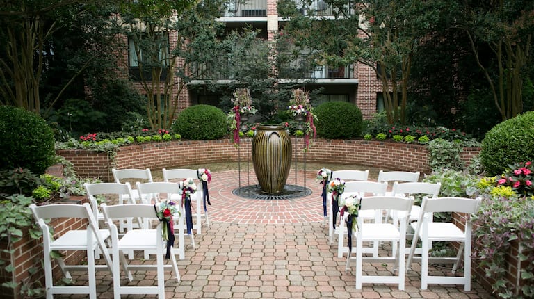 White Chairs Decorated with Flowers for and an Event on Outdoor Patio