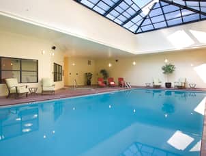 Indoor Pool and Spa With Skylight and Poolside Chairs