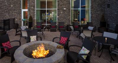 Outdoor Patio Seating Area with Armchairs, Tables and Firepit
