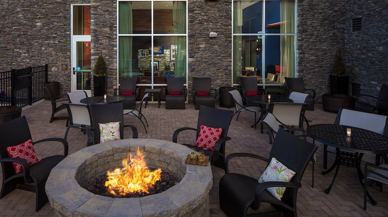 Outdoor Patio Seating Area with Armchairs, Tables and Firepit
