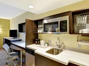 Guest Kitchen Area with Counter, Sink, Microwave, Dishwasher, Work Desk and HDTV