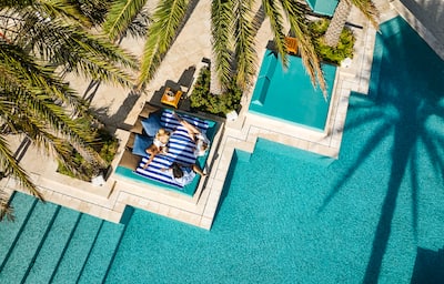 Overhead shot of women relaxing by swimming pool