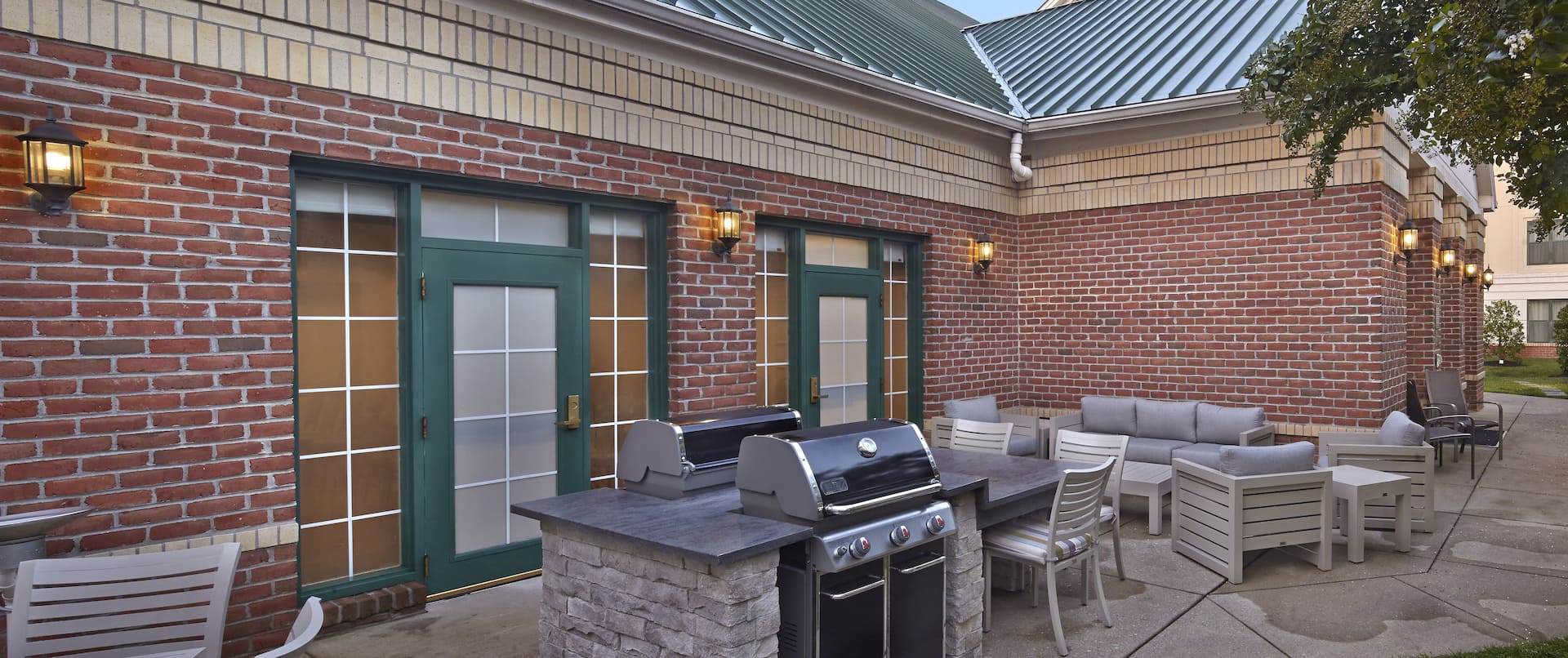 Outdoor patio area with seating and grill