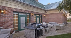 Outdoor patio area with seating and grill