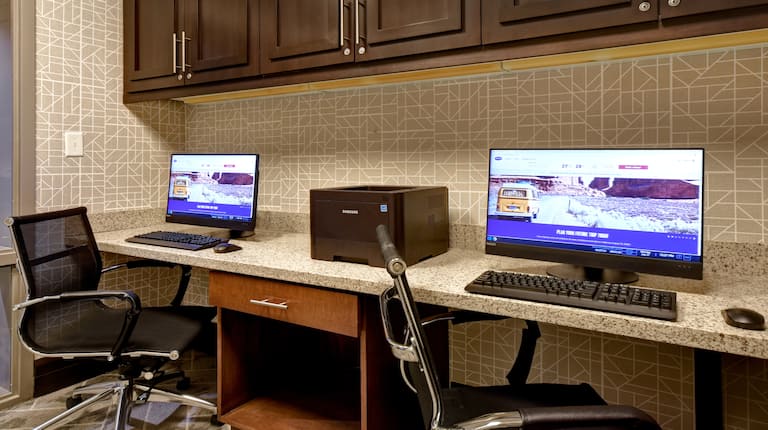 business center with two computers and printer