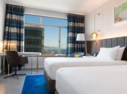 Executive Guest Room with Twin Beds Desk and Sea and City View
