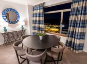 Dining Area in Panoramic Suite with City View at Night