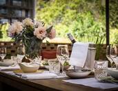 Outdoor Terrace Table with Wine Bottle in ice with Wine Glasses and Flowers