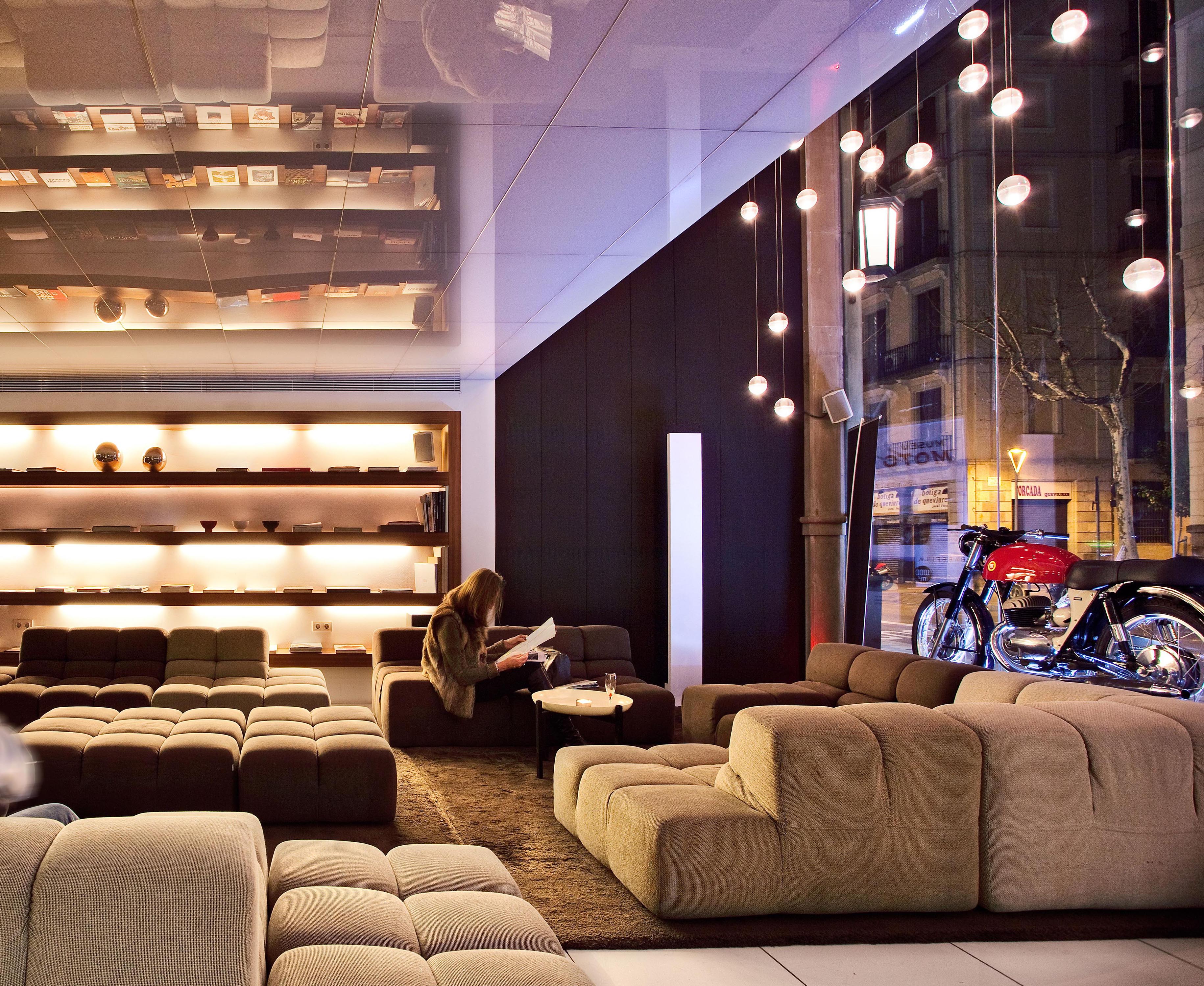 Woman Reading in Lobby Lounge Seating Area with Decorative Motorcycle