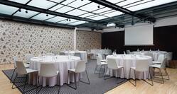 Alexandra Barcelona Curio Hotel Ballroom with Tables, Chairs, and Projector Screen