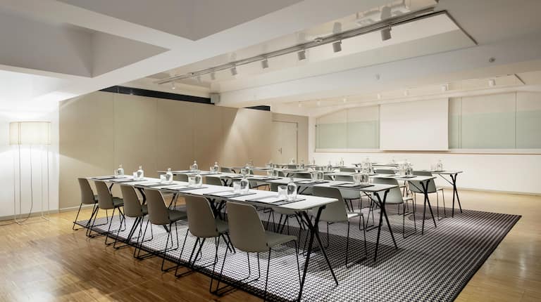 Alexandra Barcelona Curio Hotel Ballroom with Tables, Chairs, and Projector Screen