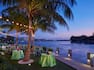 Round Event Tables Set Up With Lighting in Palm Trees By the Water at The Point