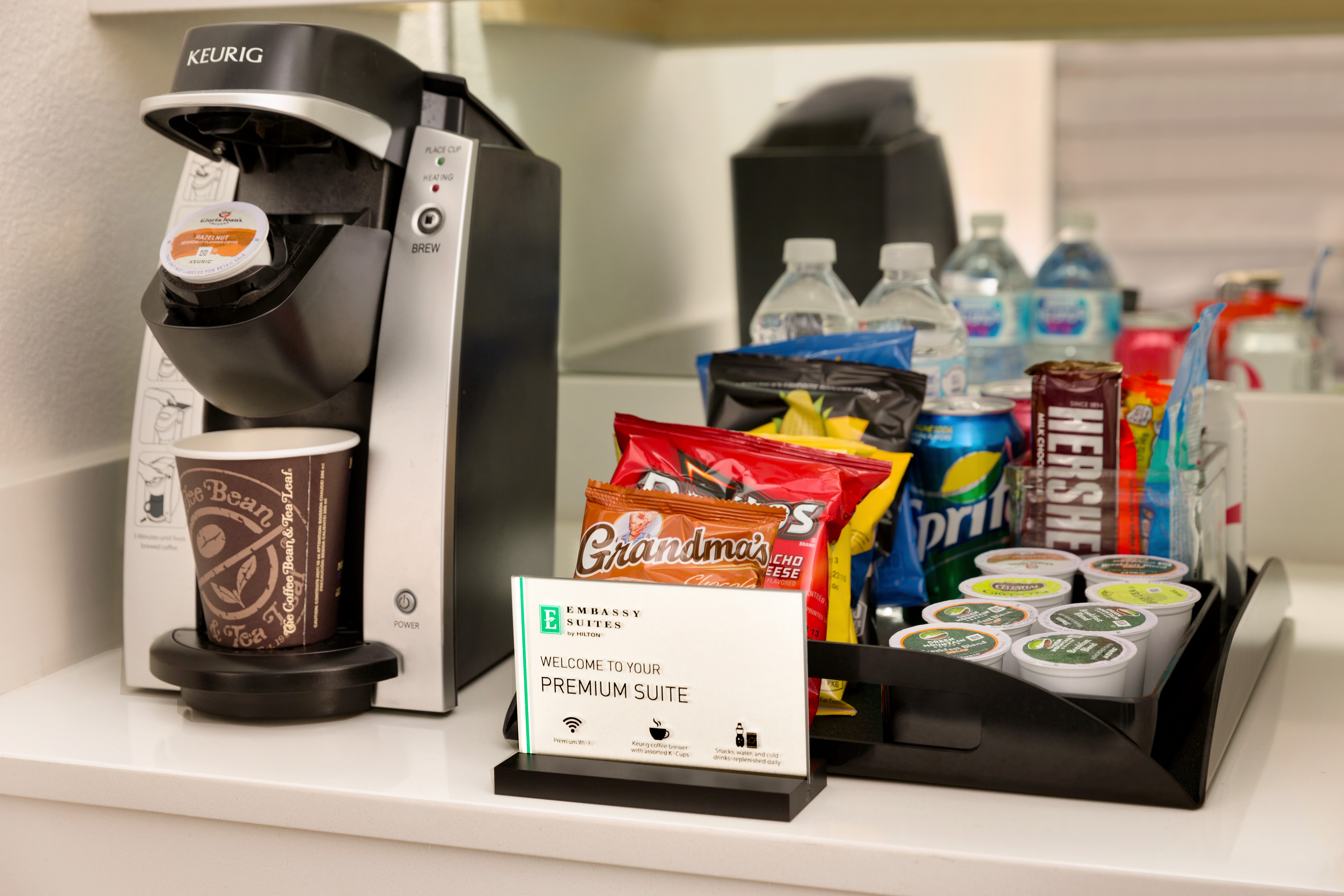 Detailed View of Keurig Coffee Maker, Signage, and Premium Suite Snack Tray 