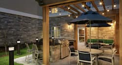 Outdoor Patio Grill and Lounge Area with Pergola Overhang with Lights