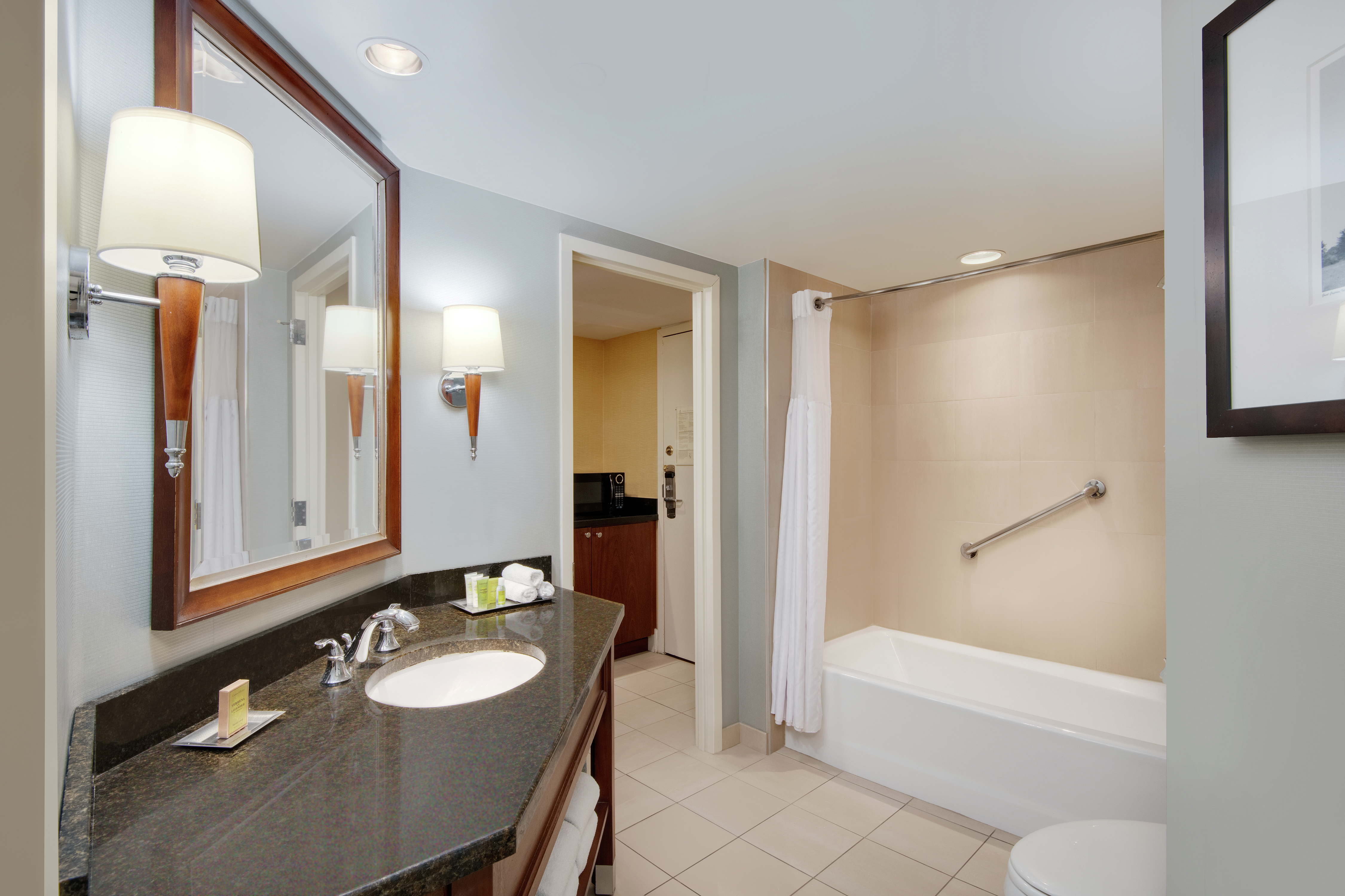 King Suite Guestroom Bathroom with Mirror, Vanity, Bathtub, and Shower